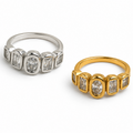 Two rings shown on a white background: one in silver-toned metal and one in yellow gold-toned metal, both featuring a row of baguette and oval-cut stones.