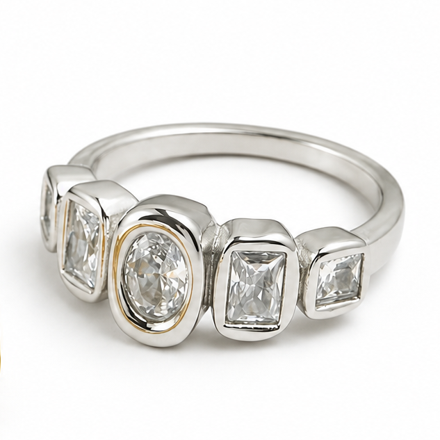 Two rings shown on a white background: one in yellow gold and one in silver. Each ring features a channel setting with three marquise-cut stones and one larger oval-cut stones